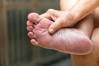 A close up of a person holding their foot