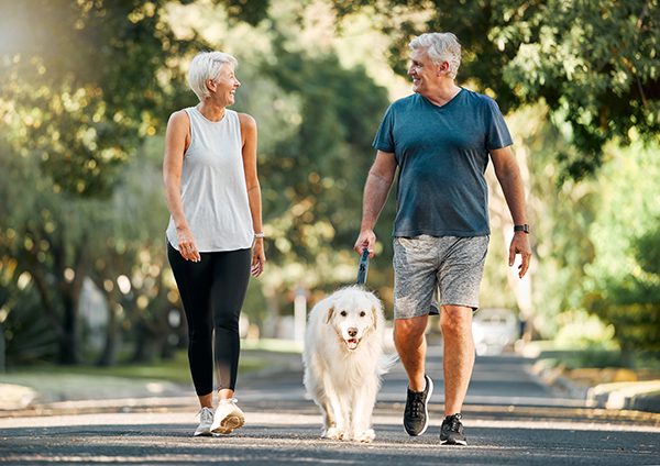 Montana couple walking their dog and maintaining and active lifestyle
