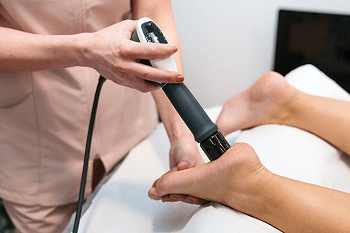A patient recieves a Shockwave Therapy treatment from a Podiatrist in Missoula, MT