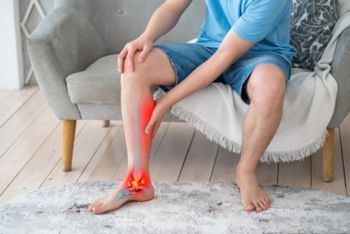 A man experiencing Achilles tendonitis pain