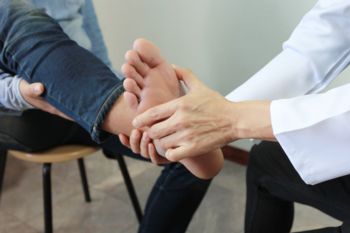 A podiatrist examining a patient's foot